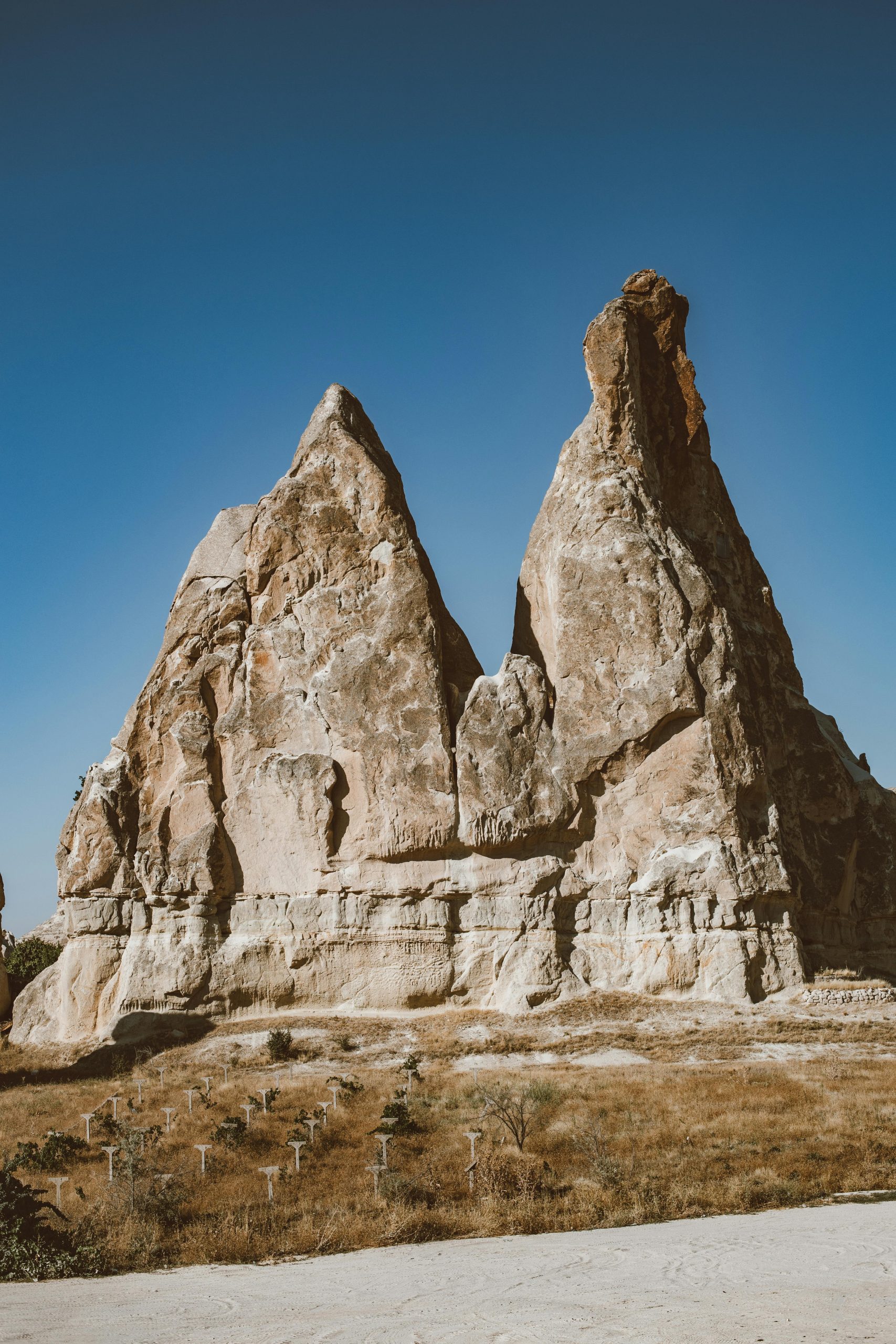 Vertical shot of limestone rock formations under a clear blue sky, showcasing geological features and natural beauty.
